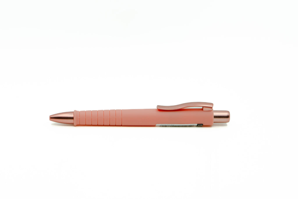 Pink pen with rose gold accents on a white background